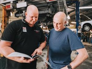 Mechanic Discussing Suspension Services And Repair With Man